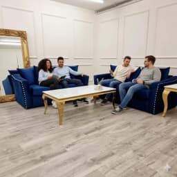 friends in a living room sitting on 3 and 2 seater sofa set