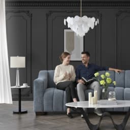 a couple sitting on a sofa and having a good time