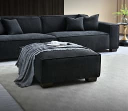 3 seater sofa with a footstool at the centre