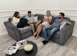 people sitting on a 4 seater corner sofa at home