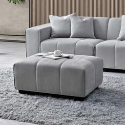 right corner sofa left end with a footstool and coffee on it.