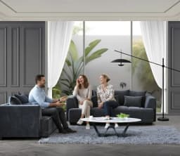 friends enjoying laughter while sitting on a sofa set