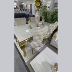 A picture of a marble dining table with gold legs